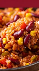 Vegetarische Reispfanne mit Kidneybohnen, Mais und Paprika auf einem Teller